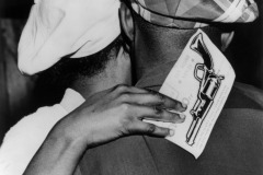 The Lottery Ticket. A New York couple in an affectionate embrace. The woman holds a lottery ticket for a free pass to the Randolph Scott film \'Colt .45\' in her hand. circa 1950. By Weegee (Arthur Fellig).