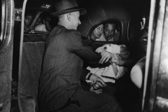 Hurt And Busted. 16-year-old Harold Horn, who stole a car and collided with a milk wagon and a truck in New York is handcuffed and bundled into a police car. The driver of the milk wagon was seriously hurt, and Harold himself suffered injuries in the crash. 27th June 1941. By Weegee (Arthur Fellig).