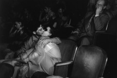 Screen Lovers. Two lovers at the Palace Theatre kissing in the front row. Taken with infrared negative. Circa 1945. By Weegee (Arthur Fellig).