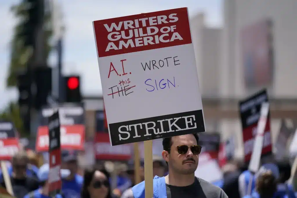 Writers strike with a sign against AI