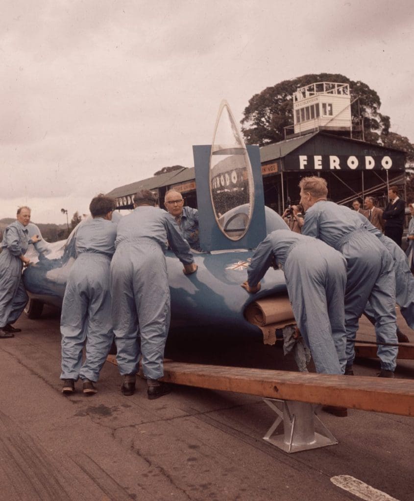 Mechanics unloading Donald Campbell's racing car on to a race track, 1960. By Hulton Archive